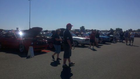 1978 Ford Mustang II - Outdoor car show with multiple vehicles and attendees on a sunny day.