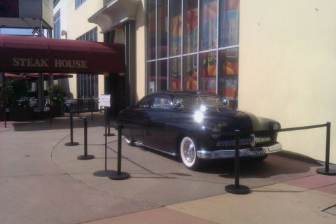 1991 Ford LTD Crown Victoria - A classic black coupe with whitewall tires is displayed outside a steakhouse.