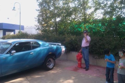 1991 Ford LTD Crown Victoria - Side view of a blue muscle car parked outdoors with people and a fire hydrant present.