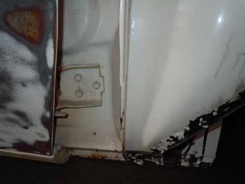 1973 Pontiac Trans Am - Rust and damage are visible around the door hinge area of this vehicle.