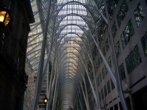 1999 Ford Crown Victoria - The striking architecture of a modern building features a grand arched glass ceiling and symmetrical window facades.