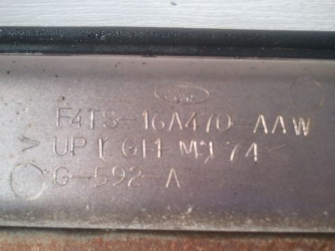 1996 Ford Bronco - Close-up of a vehicle part showing a Ford logo and stamped identification numbers, including '1974'.