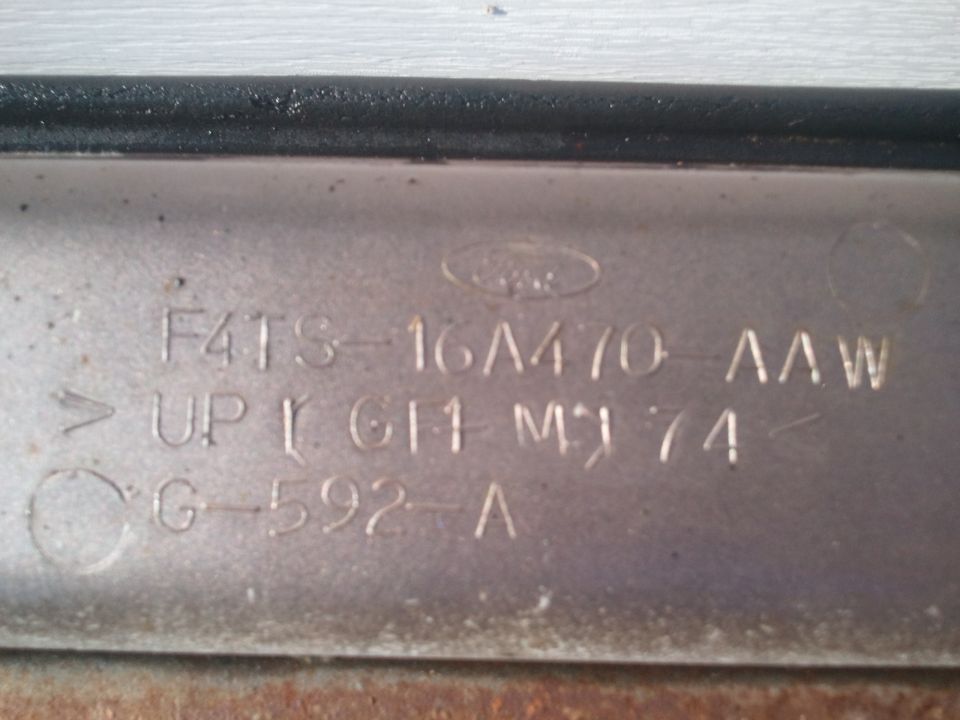 Part with Ford logo and stamped numbers, including '1974'