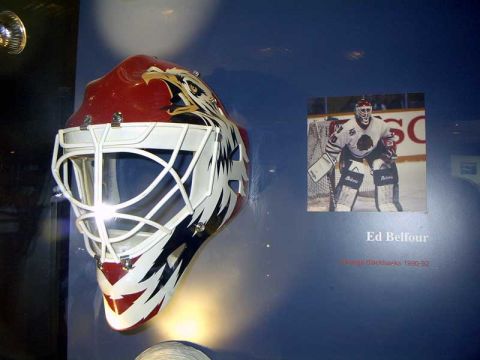 1999 Ford Crown Victoria - A hockey goalie mask and a photo of Ed Belfour are displayed on a blue wall.