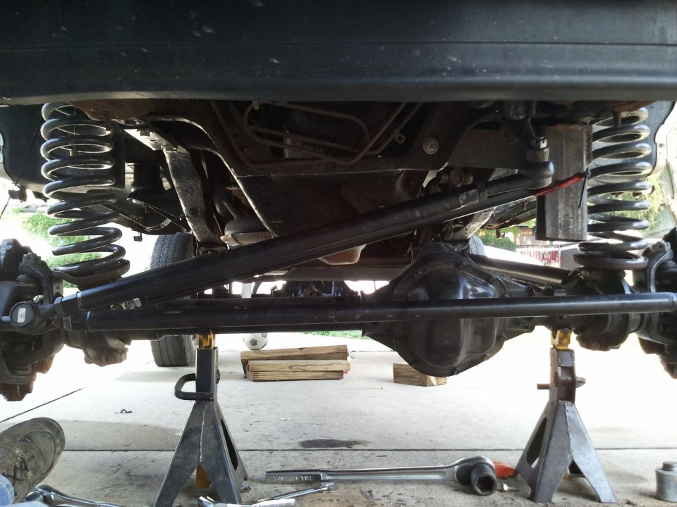 Undercarriage view of a vehicle's suspension and drivetrain components