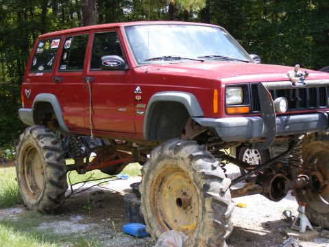 1978 Ford Bronco - This red Jeep Cherokee XJ is heavily modified with oversized tires and a lifted suspension.