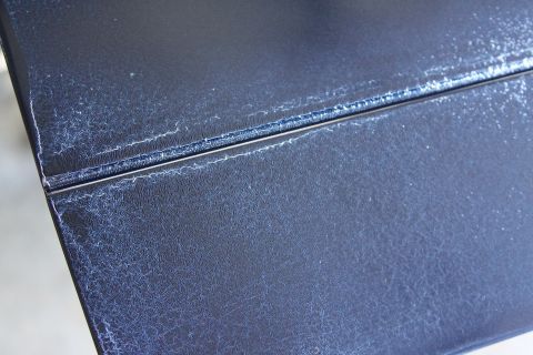 2006 Ford F-350 - Close-up of a dark blue textured surface showing signs of wear and cracking, with a visible seam.
