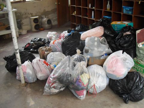 1986 Ford Bronco - A collection of assorted trash bags and boxes are gathered on the floor of a room.