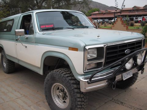 1986 Ford Bronco - This 1986 Ford Bronco features a two-tone paint scheme and is equipped with off-road tires and a brush guard.