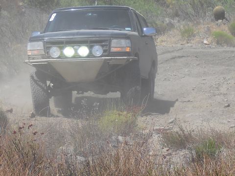 1986 Ford Bronco - This modified 1992 Ford Bronco navigates a dusty off-road trail.