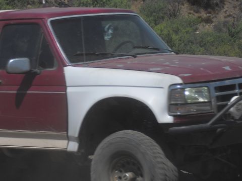 1986 Ford Bronco - This Ford Bronco, likely from the 1987-1991 generation, features a two-tone red and white paint scheme.