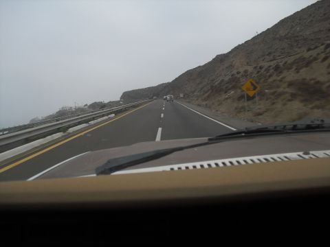1986 Ford Bronco - Driving on a highway with a mountain range to the right and other vehicles ahead.