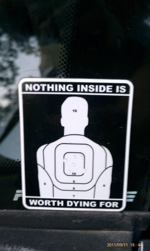 1994 Ford Probe - A sticker on a car window displays a shooting target with a humorous warning.