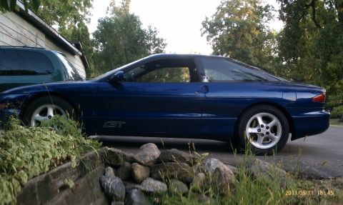 1994 Ford Probe - Side view of a blue 1994 Ford Probe GT with a GT badge on the door.