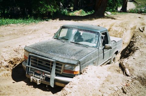 1995 Ford Bronco - This Ford truck is stuck in a deep dirt trench on an off-road trail.