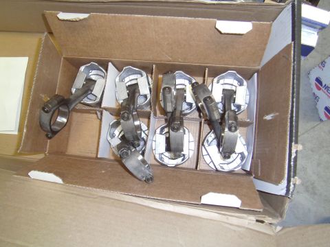1991 Chevrolet Blazer - A set of pistons and connecting rods are neatly arranged in a cardboard box.