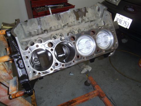 1991 Chevrolet Blazer - Engine block with pistons on a stand, with a license plate in the background.