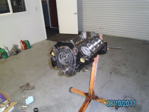 1991 Chevrolet Blazer - An engine block is displayed on a stand in a garage setting, with various automotive fluids nearby.