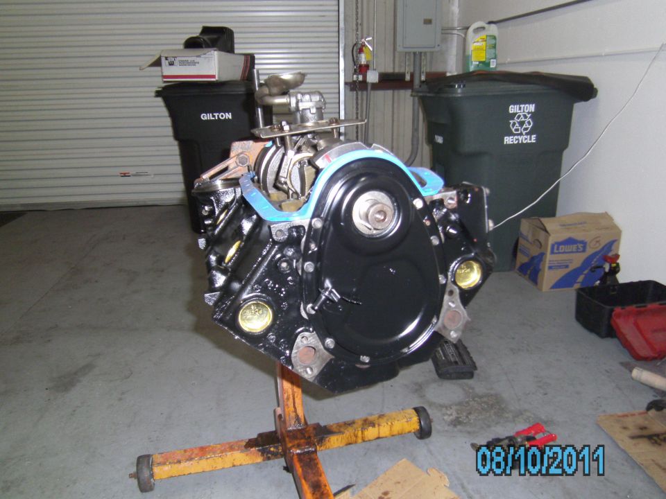 Black engine block on yellow stand, front view