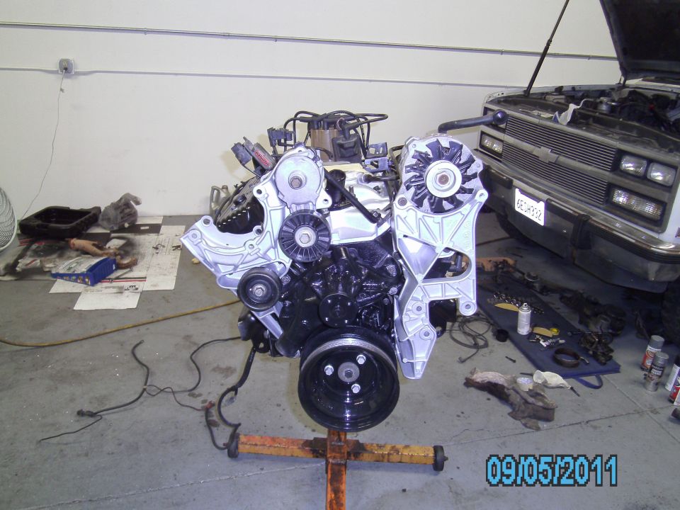 Engine on a stand, with a truck in the background