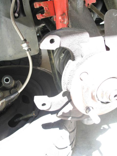 1993 Mazda MX-3 - Brake caliper and rotor assembly shown in detail, likely part of a vehicle's suspension system.