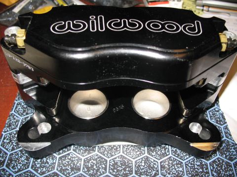 1993 Mazda MX-3 - Close-up of a black Wilwood brake caliper, highlighting its construction and branding.
