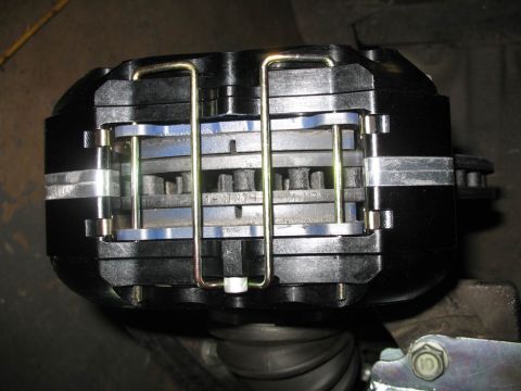 1993 Mazda MX-3 - Close-up of a performance brake caliper assembly, showing multiple brake pads.