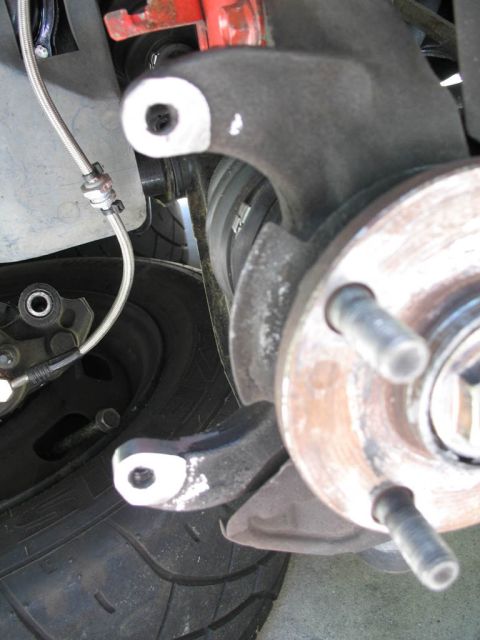 1993 Mazda MX-3 - Front brake components including caliper, rotor, and wheel hub are visible in this close-up shot.