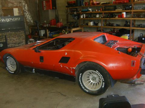2000 Ford E350 - This orange sports car appears to be a kit car or custom build, with its unique body style and exposed engine components.