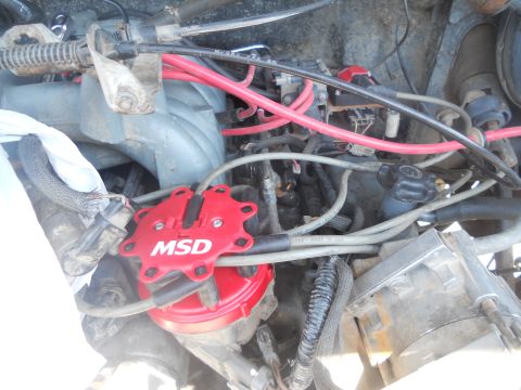 1991 Ford Bronco - Close-up of an engine bay an MSD distributor cap and wiring.