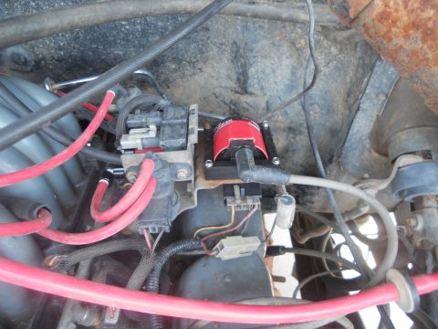 1991 Ford Bronco - Close-up view of the engine's ignition system components, including the coil and wiring harness.