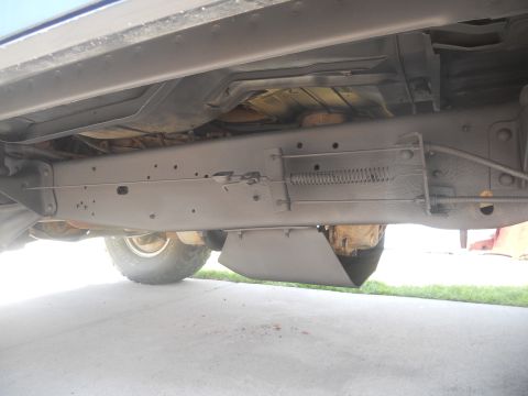 1991 Ford Bronco - Underside view of a vehicle's frame, suspension, and a tire. The Supermotors.net logo is present in the lower right corner.