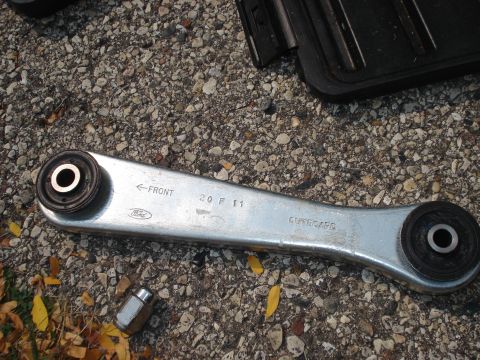 2000 Ford Crown Victoria - A Ford rear control arm is shown, directional and date markings.