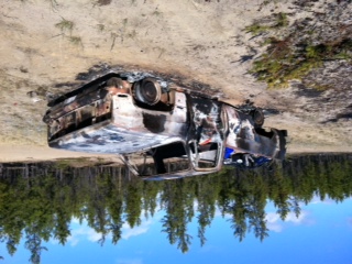1986 Ford F-150 - This pickup truck appears to have been involved in a fire and is now overturned.