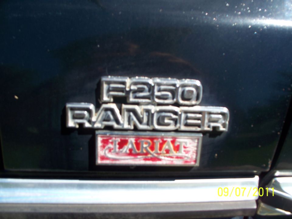 Close-up of F250 Ranger Lariat badging on a dark vehicle
