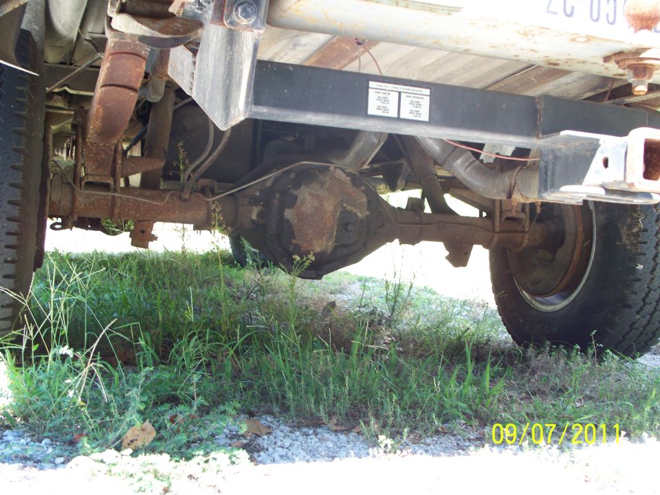Rear axle, leaf springs, and trailer hitch of a truck. Date stamp reads 09/07/2011