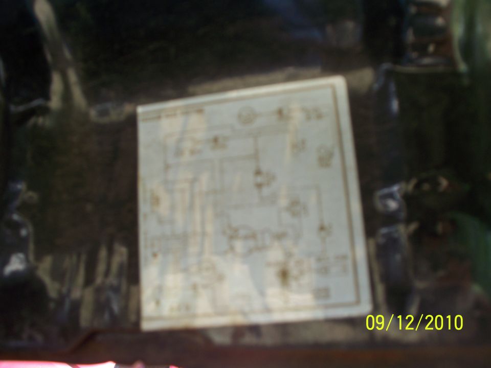 Wiring diagram sticker on a dark surface. Date and website watermark visible