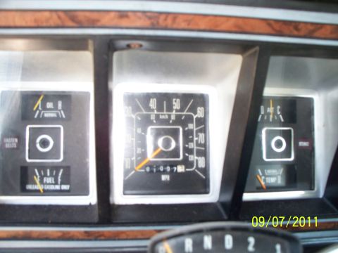 1979 Ford F-250 - The interior of a 1979 Ford F-250 shows a dashboard with multiple gauges and wood-grain trim.