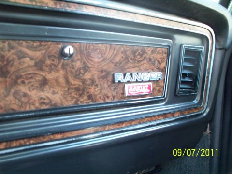 1979 Ford F-250 - Interior dashboard trim on a 1979 Ford F-250 Ranger XLT, showing woodgrain and an air vent.