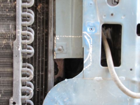 1993 Ford F-250 - Close-up view of engine bay components, including radiator and metal framing, with visible markings.