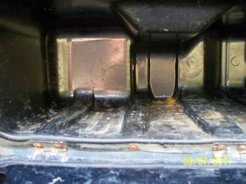 1979 Ford F-250 - Close-up view of the inside of a truck bed, focusing on the latches and floor structure.