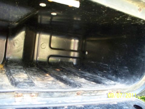 1979 Ford F-250 - This is a view inside a dark, empty storage compartment within a vehicle's interior.