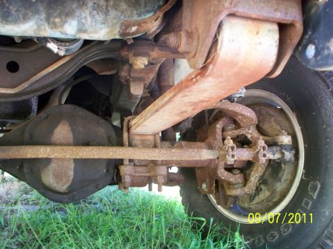 1979 Ford F-250 - The underside of a truck shows significant rust on the suspension components and rear differential.
