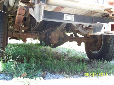 1979 Ford F-250 - The rear axle and suspension of a 1979 Ford F-250 are visible, with significant rust present.