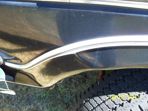 1979 Ford F-250 - Detail of the fender and tire on a 1979 Ford F-250, showing chrome trim and a portion of the wheel.