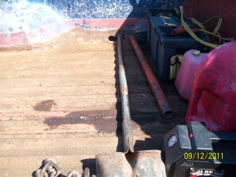 1979 Ford F-150 - Contents of a truck bed include a gas can, toolbox, chains, and metal pipes, with a date stamp visible.