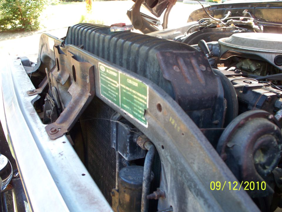 close-up of a vehicle's engine bay, showing the radiator and some engine components