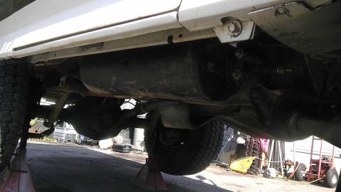 1989 Ford Bronco - The underside of a 1989 Ford Bronco, highlighting its rear axle and fuel tank assembly.