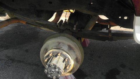 1989 Ford Bronco - Close-up view of the rear suspension and axle components of a vehicle.