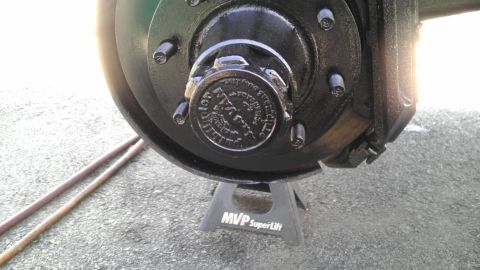 1989 Ford Bronco - Close-up of the front wheel hub assembly on a 1989 Ford Bronco, showing the brake rotor and a cap with visible text.